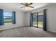Bedroom featuring a sliding glass door leading to a patio and a large window at 3815 Se 25Th St, Bushnell, FL 33513
