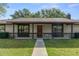 Charming single-story home featuring stone accents, a covered porch, and a beautifully landscaped front yard at 3815 Se 25Th St, Bushnell, FL 33513