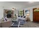 Cozy living room featuring a stone fireplace, comfortable seating, and a modern design at 3815 Se 25Th St, Bushnell, FL 33513