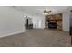 Spacious living room with a striking stone fireplace, ceiling fan, and seamless flow to the dining area at 3815 Se 25Th St, Bushnell, FL 33513