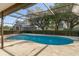 Cool off in the screened in pool surrounded by lush landscaping and open pasture views at 3815 Se 25Th St, Bushnell, FL 33513
