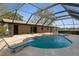 The beautiful pool is surrounded by a screened enclosure and overlooks the home's large lot at 3815 Se 25Th St, Bushnell, FL 33513