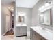 Bathroom with dual vanities, a glass-enclosed shower, and neutral tiling at 4649 Sw 103Rd Street Rd, Ocala, FL 34476