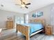 Bedroom featuring wood-look floors, a decorative wall piece, and a sliding door to the outside at 4649 Sw 103Rd Street Rd, Ocala, FL 34476