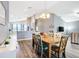 Dining area featuring wood floors, chandelier lighting, and views into the kitchen and living room at 4649 Sw 103Rd Street Rd, Ocala, FL 34476