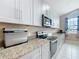 Well-equipped kitchen features granite countertops, stainless steel appliances, and plenty of counter space at 4649 Sw 103Rd Street Rd, Ocala, FL 34476