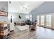 Bright living room with vaulted ceilings, hardwood floors, and access to the backyard through French doors at 4649 Sw 103Rd Street Rd, Ocala, FL 34476