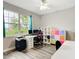 Bright office space with a large window, wood-look flooring, desk, and colorful storage cubbies at 4649 Sw 103Rd Street Rd, Ocala, FL 34476