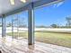 View of backyard from screened-in porch with tiled floor at 4649 Sw 103Rd Street Rd, Ocala, FL 34476