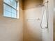 Walk-in shower with neutral tiling, a showerhead, and a built-in soap dish at 4649 Sw 103Rd Street Rd, Ocala, FL 34476