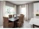Cozy dining room area featuring modern curtains and chair setup next to a large window at 11018 Nellie Crossing Cir, Clermont, FL 34711