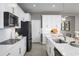 Contemporary kitchen with white cabinetry, a marble island, and stainless steel appliances at 11018 Nellie Crossing Cir, Clermont, FL 34711