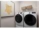 Contemporary laundry room with a new washer and dryer set and decor at 11018 Nellie Crossing Cir, Clermont, FL 34711