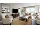 Inviting living room with neutral tones, comfortable seating, and large windows for natural light at 11018 Nellie Crossing Cir, Clermont, FL 34711