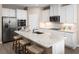 Contemporary kitchen with granite countertops, stainless steel appliances, and a central island with bar stool seating at 11030 Nellie Crossing Cir, Clermont, FL 34711