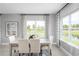 Dining room with elegant decor, with large windows offering scenic views, creating a serene atmosphere for meals at 11054 Nellie Crossing Cir, Clermont, FL 34711
