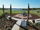 Community playground with modern equipment, surrounded by lush landscaping and nearby seating at 11054 Nellie Crossing Cir, Clermont, FL 34711