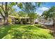 Green lawn and mature trees surrounding the home provide a private backyard retreat at 1711 Tierra Alta Dr, Lakeland, FL 33813