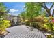 Wooden deck and lush landscaping create a serene outdoor living space at 1711 Tierra Alta Dr, Lakeland, FL 33813
