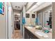 Bathroom featuring a dual-sink vanity, skylight, and a walk-in closet for ample storage and convenience at 1711 Tierra Alta Dr, Lakeland, FL 33813