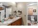 Bathroom with double sinks, a large mirror, and a separate toilet room at 1711 Tierra Alta Dr, Lakeland, FL 33813