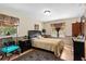 Bedroom featuring a queen-size bed, dark furniture, and a lamp at 1711 Tierra Alta Dr, Lakeland, FL 33813