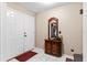 Home foyer featuring tiled floors, coat closet, a wooden console table and a decorative mirror at 1711 Tierra Alta Dr, Lakeland, FL 33813