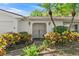 Close up of the home's front entrance featuring a gated entry, tiled walkway and decorative shrubs at 1711 Tierra Alta Dr, Lakeland, FL 33813