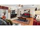 Spacious living room featuring wood floors, comfortable seating, and an open layout to the kitchen at 1711 Tierra Alta Dr, Lakeland, FL 33813
