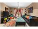 Cozy living room with colorful decor, ample seating and a large window with bright, patterned curtains at 1711 Tierra Alta Dr, Lakeland, FL 33813