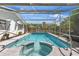 Sparkling pool with attached spa, caged in for added privacy and relaxation at 1711 Tierra Alta Dr, Lakeland, FL 33813