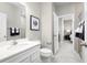 Bright bathroom features tiled floors, white cabinets, modern fixtures, and a glass-enclosed shower at 3034 Cayey Way, Clermont, FL 34711