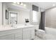Bright bathroom features double sinks, white cabinets, and a shower-tub combo at 3034 Cayey Way, Clermont, FL 34711