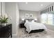 Modern bedroom with neutral walls, tile flooring, a bed with clean lines, and a window with a striped window shade at 3034 Cayey Way, Clermont, FL 34711