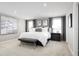 Spacious bedroom showcasing neutral walls, plush carpeting, a bed with elegant bedding, and large windows with drapes at 3034 Cayey Way, Clermont, FL 34711