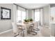 Contemporary dining area with a stylish table, comfortable seating, and large windows at 3034 Cayey Way, Clermont, FL 34711