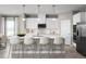Modern kitchen featuring a center island with seating, stainless steel appliances, and pendant lighting at 3034 Cayey Way, Clermont, FL 34711