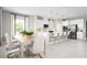 Open kitchen featuring an island with seating and a dining area with natural light at 3034 Cayey Way, Clermont, FL 34711