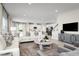Bright, open-concept living room with modern furnishings and an adjacent kitchen at 3034 Cayey Way, Clermont, FL 34711