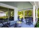 Covered patio boasts multiple seating areas, perfect for outdoor entertaining with views of a backyard at 3034 Cayey Way, Clermont, FL 34711