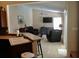 Open-concept living room featuring vaulted ceilings, ceiling fan, large windows, and tile flooring at 3850 Plantation Blvd, Leesburg, FL 34748