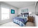 This bedroom features a blue striped comforter, black headboard, carpet, and two matching nightstands at 403 Harvard Ct, Dundee, FL 33838