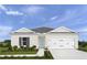 Charming single-story home with a two-car garage, blue front door, and well-manicured lawn at 403 Harvard Ct, Dundee, FL 33838