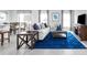 Spacious living room featuring a stylish blue rug, comfortable sofa, and dining area at 403 Harvard Ct, Dundee, FL 33838