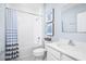 This bathroom features a white vanity with an undermount sink, tile floor, and a shower-tub combination at 416 Harvard Ct, Dundee, FL 33838