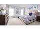 This bedroom is furnished with a queen bed, a dresser, and matching nightstands, and has an ensuite bathroom at 416 Harvard Ct, Dundee, FL 33838