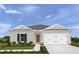 Charming single-story home with a well-manicured lawn and inviting front entrance with a gray and white color scheme at 416 Harvard Ct, Dundee, FL 33838