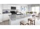 Well-lit kitchen with a granite-topped island, stainless steel appliances, and seating for casual dining at 416 Harvard Ct, Dundee, FL 33838