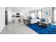Inviting living room featuring a plush sofa, a blue rug, and an open layout to the kitchen and dining area at 416 Harvard Ct, Dundee, FL 33838