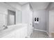 Well-lit bathroom with a spacious vanity, large mirror, and modern tile flooring at 744 Cantaberry Dr, Dundee, FL 33838